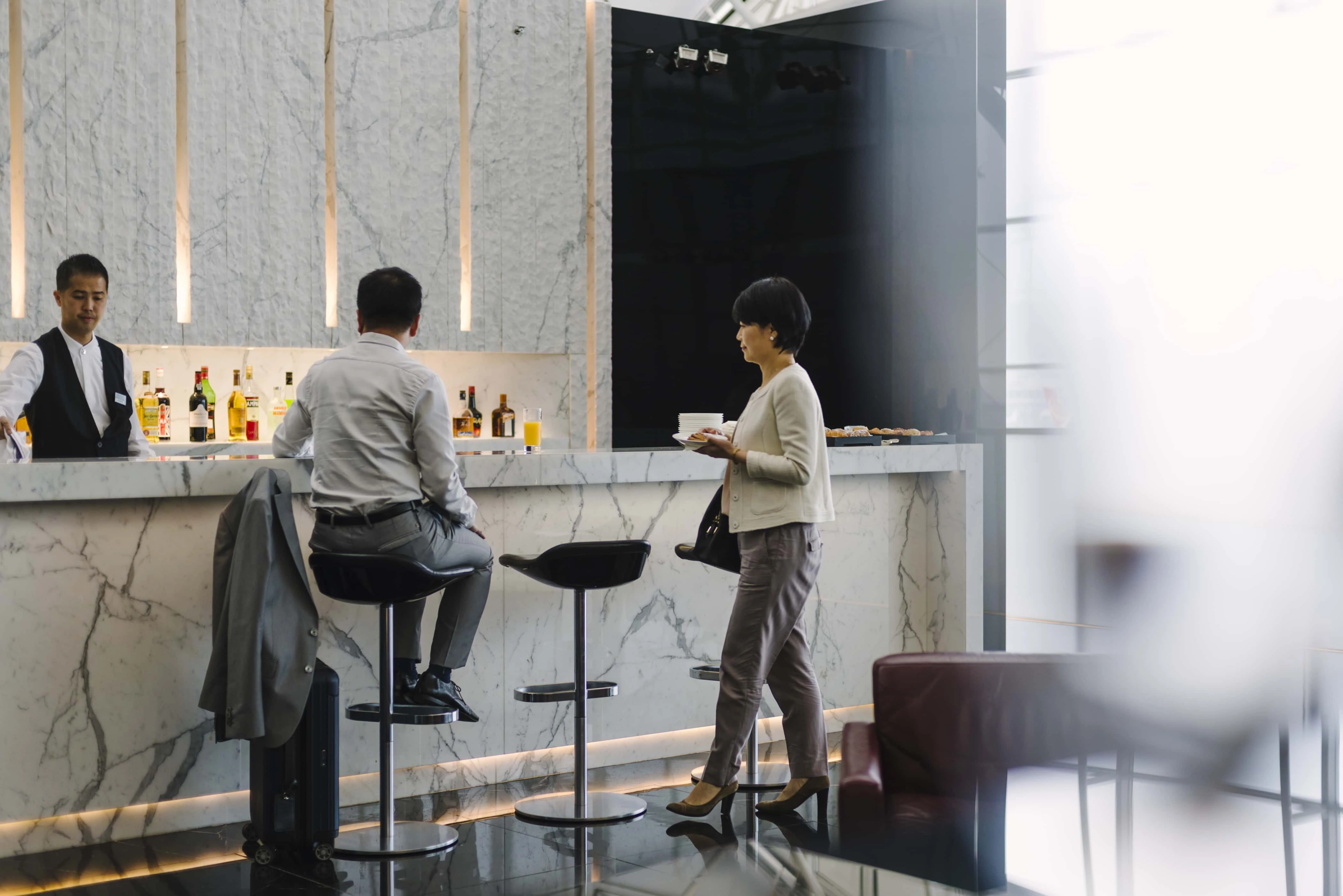 Cathay Pacific Lounge two people by a bar